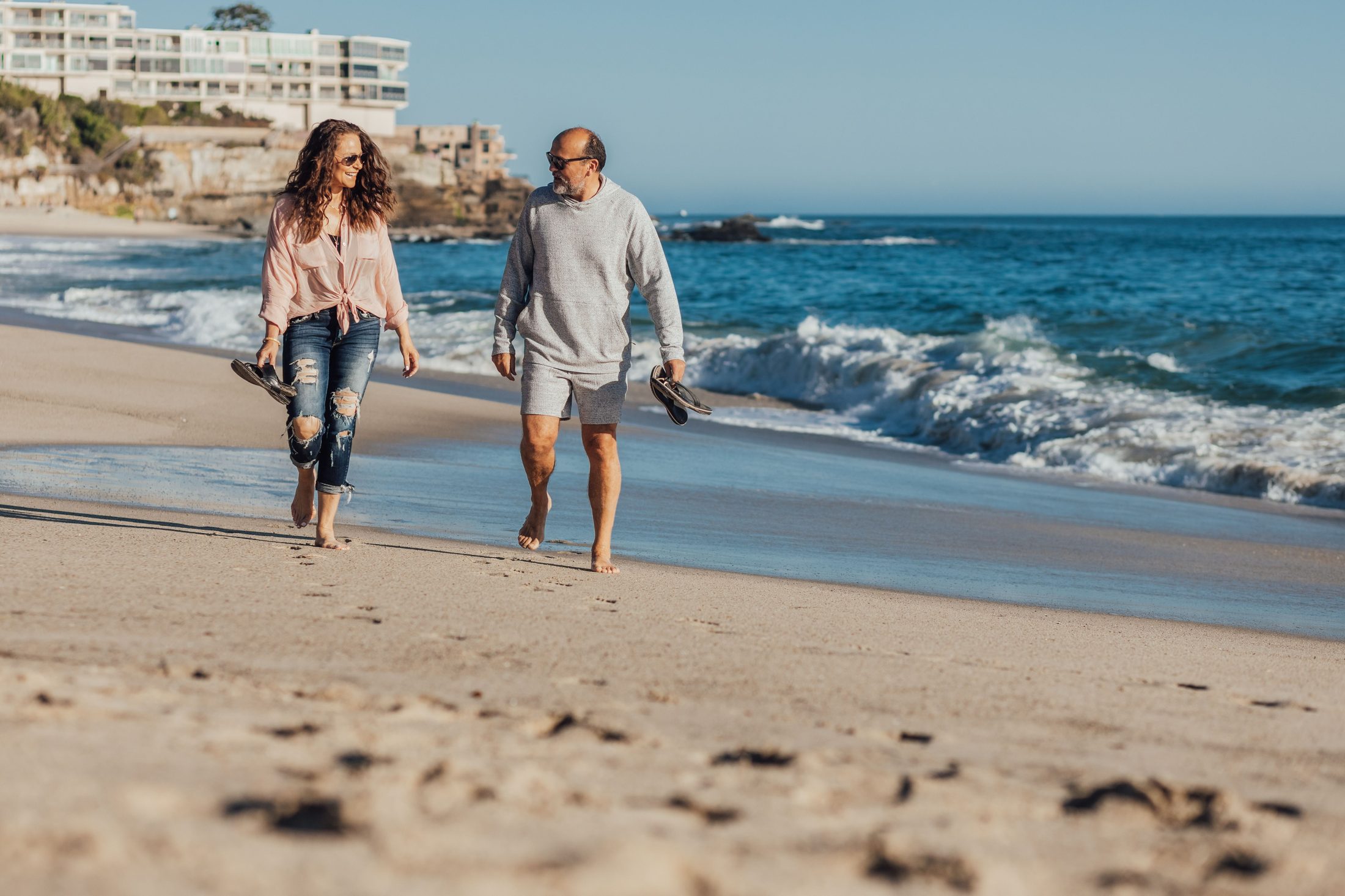 A couple enjoying a walk beside the ocean